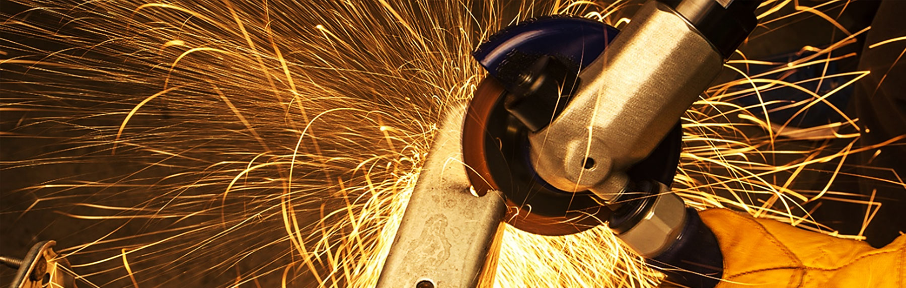 Photo of a rotary tool cutting metal as sparks fly