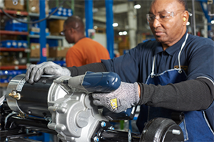 Man assembling a machine using power tools and PPE