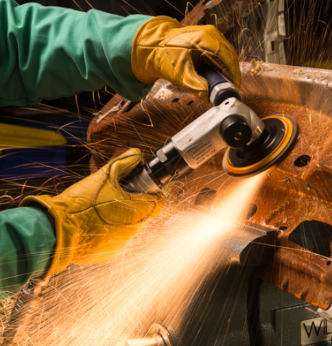 Worker using a grinder